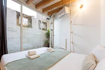 a bedroom with a bed with towels on it at Charming Retreat with Balcony in Porto
