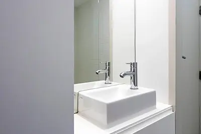 a bathroom with a white sink and a mirror at Charming Retreat with Balcony in Porto