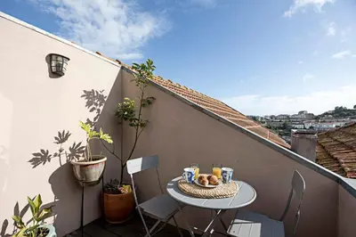 a small table and chairs on a balcony at Charming Retreat with Balcony in Porto