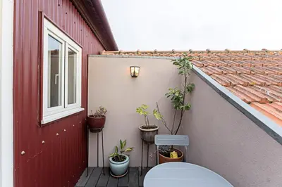 a toilet sitting on a porch next to a building at Charming Retreat with Balcony in Porto