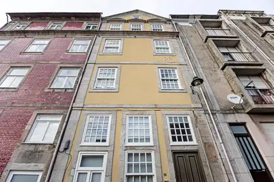 a tall building with many windows on it at Charming Retreat with Balcony in Porto