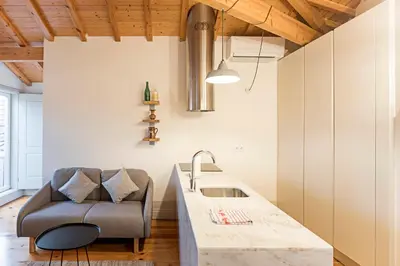 a kitchen with a couch next to a sink at Charming Retreat with Balcony in Porto