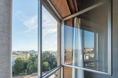 an open window with a view of a city at Woodwork Apartment in Porto