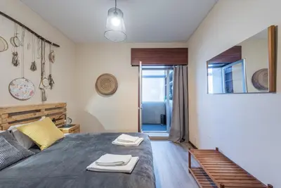 a bedroom with a bed with two towels on it at Woodwork Apartment in Porto