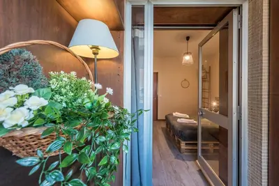 a hallway with a room with a couch and flowers at Woodwork Apartment in Porto