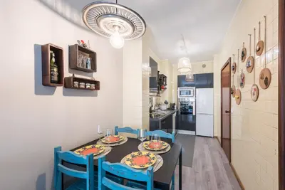 a kitchen and dining room with a table and chairs at Woodwork Apartment in Porto