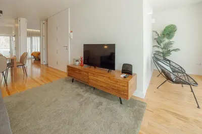 a living room with a flat screen tv on a table at Porto Panoramic Views With Terrace by Vacationy in Porto