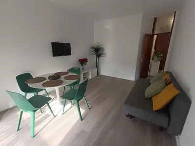 a room with a table with a lamp and a bedroom at Camões Appartments in Porto