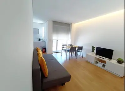 a bedroom with a bed in a white room at Camões Appartments in Porto