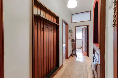 a hallway with wooden doors in a house at Apartamento com terraço in Porto
