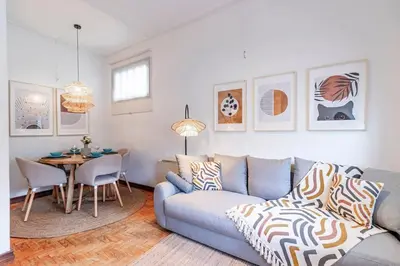 a living room with a couch and a table at Apartamento com terraço in Porto