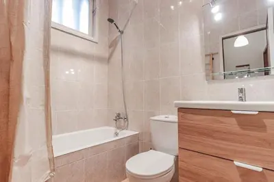a bathroom with a toilet and a sink and a shower at Apartamento com terraço in Porto