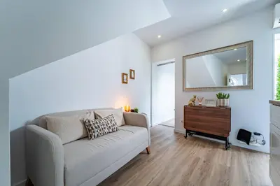 a living room with a couch and a mirror at Oporto Nura Apartment Downtown in Porto