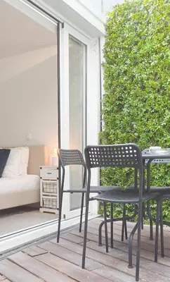 two chairs and a table on a porch at Oporto Nura Apartment Downtown in Porto