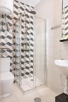 a shower in a bathroom with a toilet and a sink at C&P Bolhão Downtown Studio in Porto