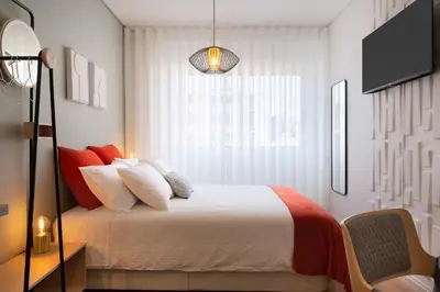 a bedroom with a large bed with a window at C&P Bolhão Downtown Studio in Porto