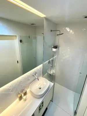 a white bathroom with a sink and a shower at Cozy Studio in the Heart of Porto in Porto