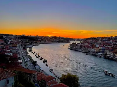 a view of a river in a city at sunset at Cozy Studio in the Heart of Porto in Porto