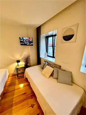 a bedroom with a large bed in a room at Cozy Studio in the Heart of Porto in Porto