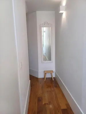 a small hallway with a table and a mirror at Foryou-2-BonfimPorto in Porto