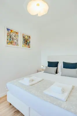 a white bedroom with two beds and a couch at Rola Art Work Studio II by DA'HOME in Porto