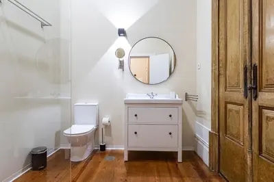 a bathroom with a toilet and a mirror at Guesthouse Bonjardim by LovelyStay in Porto