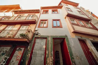 a tall white building with windows and balconies at Charming Tiny House by Hosty in Porto