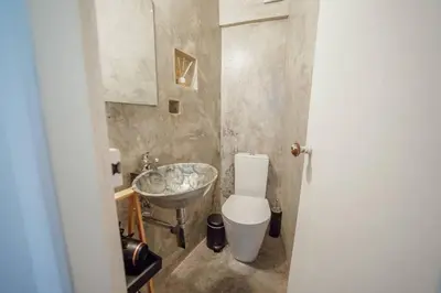 a bathroom with a toilet and a sink at Charming Tiny House by Hosty in Porto