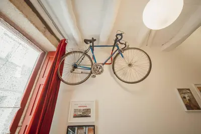 a bike hanging on a wall in a room at Charming Tiny House by Hosty in Porto
