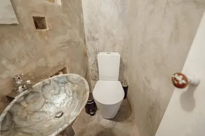 a bathroom with a toilet and a sink at Charming Tiny House by Hosty in Porto