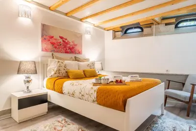 a bedroom with a king sized bed with orange sheets at Host Wise - Colourful Cozy Flat in Porto