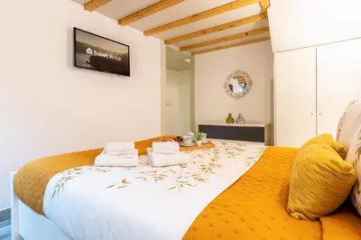 a bedroom with a large white bed with two pillows at Host Wise - Colourful Cozy Flat in Porto