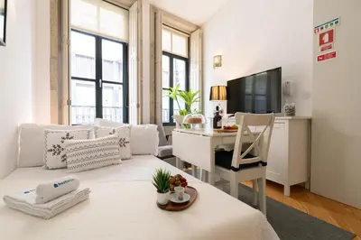 a living room with a white couch and a desk at Host Wise - Colourful Cozy Flat in Porto
