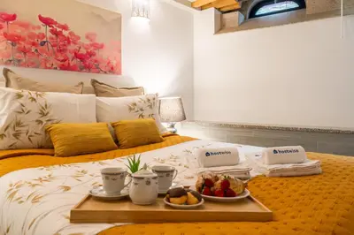 a breakfast tray on a bed with fruit on it at Host Wise - Colourful Cozy Flat in Porto