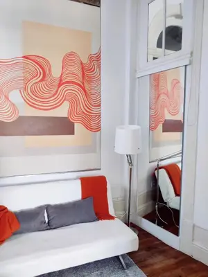 a living room with a white couch and colorful paintings at Central Stonehouse with terrace in Porto