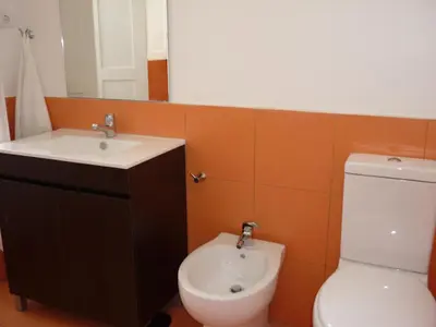 a bathroom with a toilet and a sink at Central Stonehouse with terrace in Porto