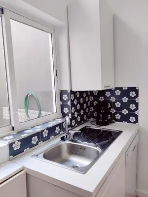 a kitchen with a sink and a window at Central Stonehouse with terrace in Porto