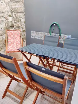 a table with two chairs and a blue table and chairs at Central Stonehouse with terrace in Porto