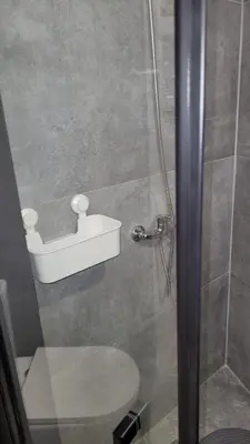 a bathroom with a toilet and a shower stall at Guest House CR5 in Porto