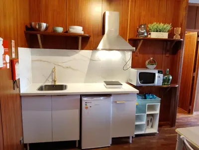 a kitchen with a sink and a microwave at Travel and Live Poveiros in Porto