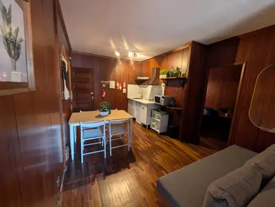 a kitchen with a table and a small kitchen with a stove at Travel and Live Poveiros in Porto