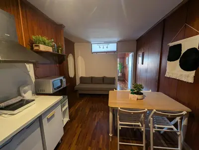 a kitchen and living room with a table and a couch at Travel and Live Poveiros in Porto