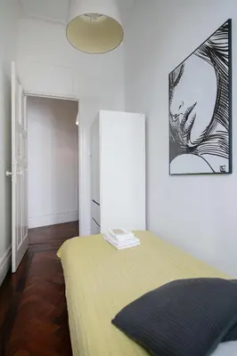 a bedroom with a bed with a yellow blanket at Baixa24 · City Center Private Sun Deck Apartment in Porto