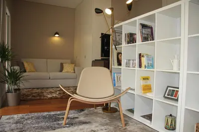 a living room with a chair and a couch at Toctoc Yellow in Porto