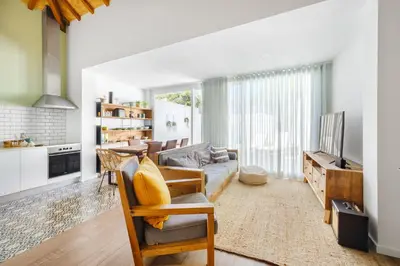 a living room with a couch and a table at Green Tiles House in Porto