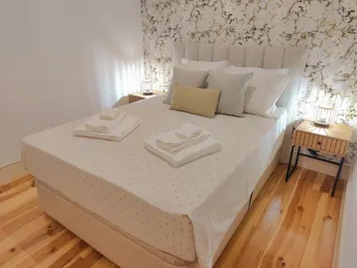 a bedroom with a bed with two towels on it at Premium Apartment Porto Downtown - Bonjardim in Porto