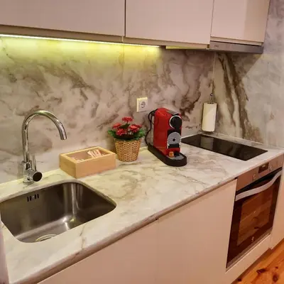 a kitchen counter with a sink and a mixer at Premium Apartment Porto Downtown - Bonjardim in Porto