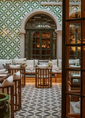 a room with tables and couches in a building at Palacete Severo in Porto