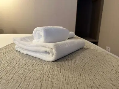 a pile of towels sitting on top of a bed at Lit Apartments - CLÉRIGOS in Porto