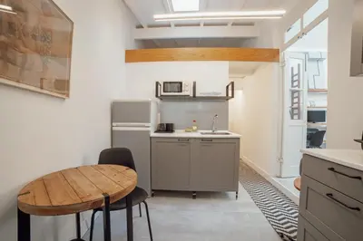 a small kitchen with a sink and a table at Clerigos Loft by Hosty in Porto